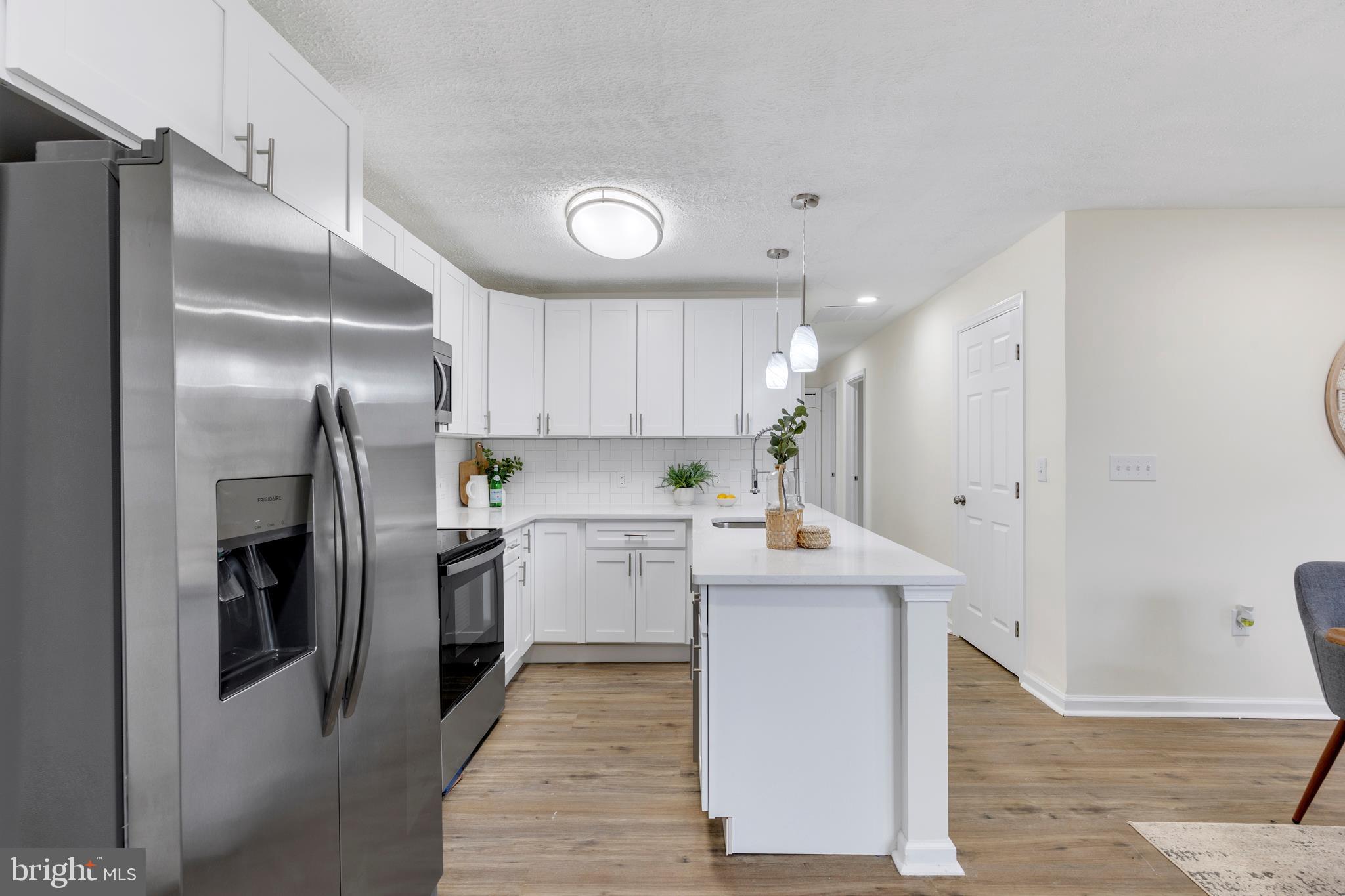 723 Cotter Road Glen Burnie, MD 21060 - Photo 3 of 31 a kitchen with a refrigerator sink and cabinets