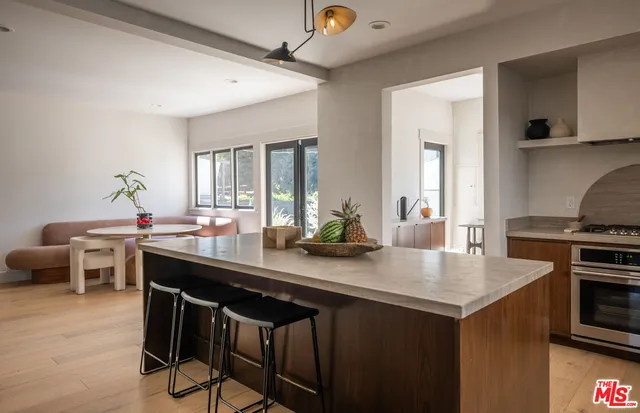 a kitchen with a sink cabinets and wooden floor