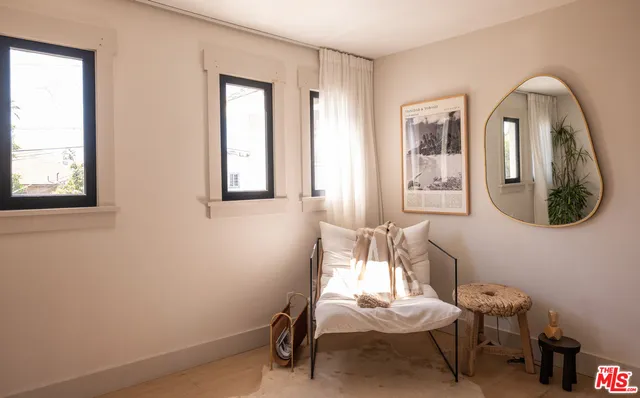 a room with lounge chair and windows