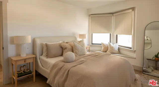 a bedroom with a bed and a mirror