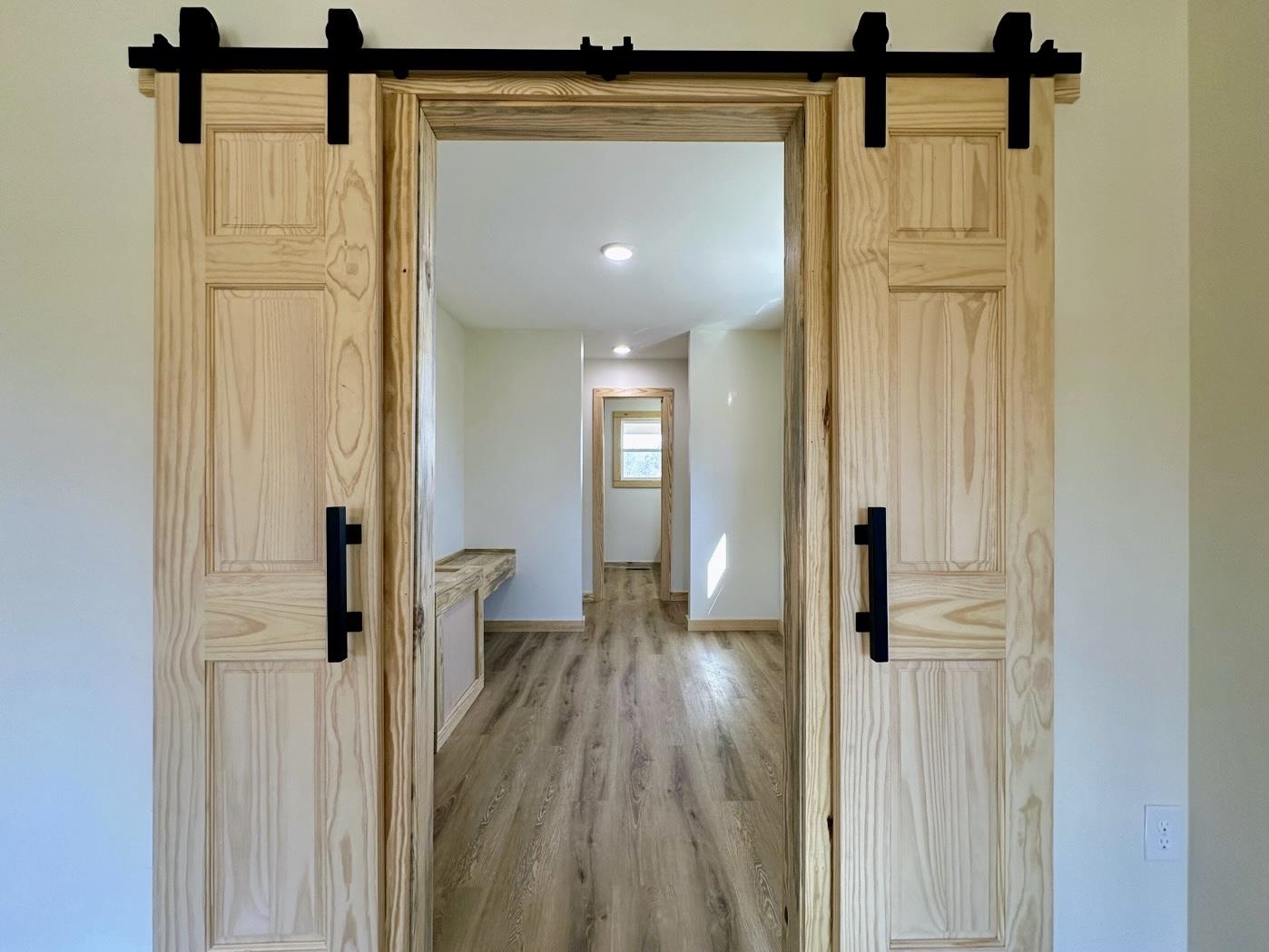 3840 Federal Road Counce, TN 38326 - Photo 16 of 40 Corridor with a barn door and wood finished floors