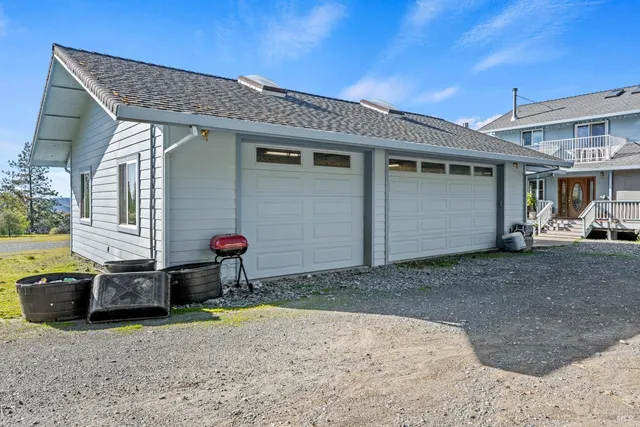 a view of a house with backyard and porch