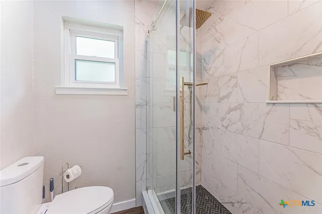 a white toilet sitting next to a bathroom sink