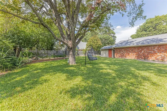a view of house with backyard