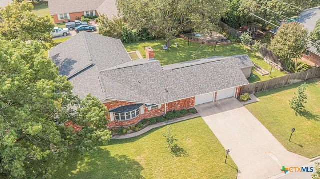 an aerial view of residential house with swimming pool and outdoor space