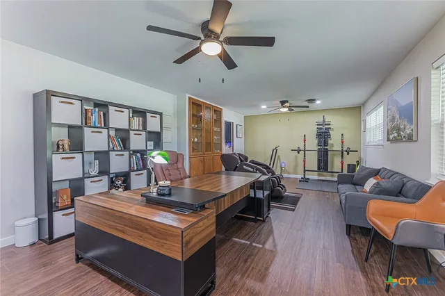 a living room with furniture and a book shelf