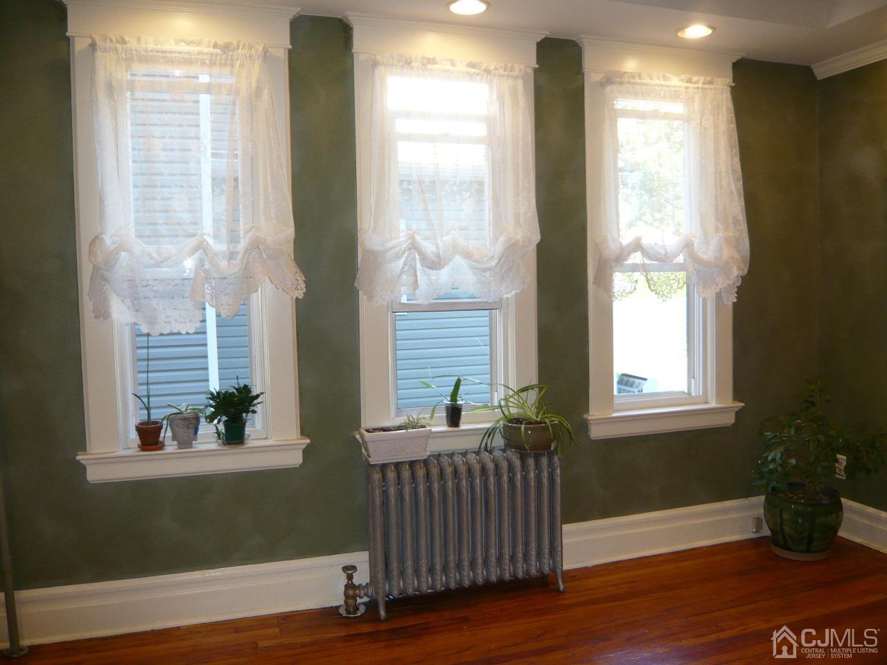 232 Rector Street Perth Amboy, NJ 08861 - Photo 13 of 31 a view of an empty room with wooden floor and a window
