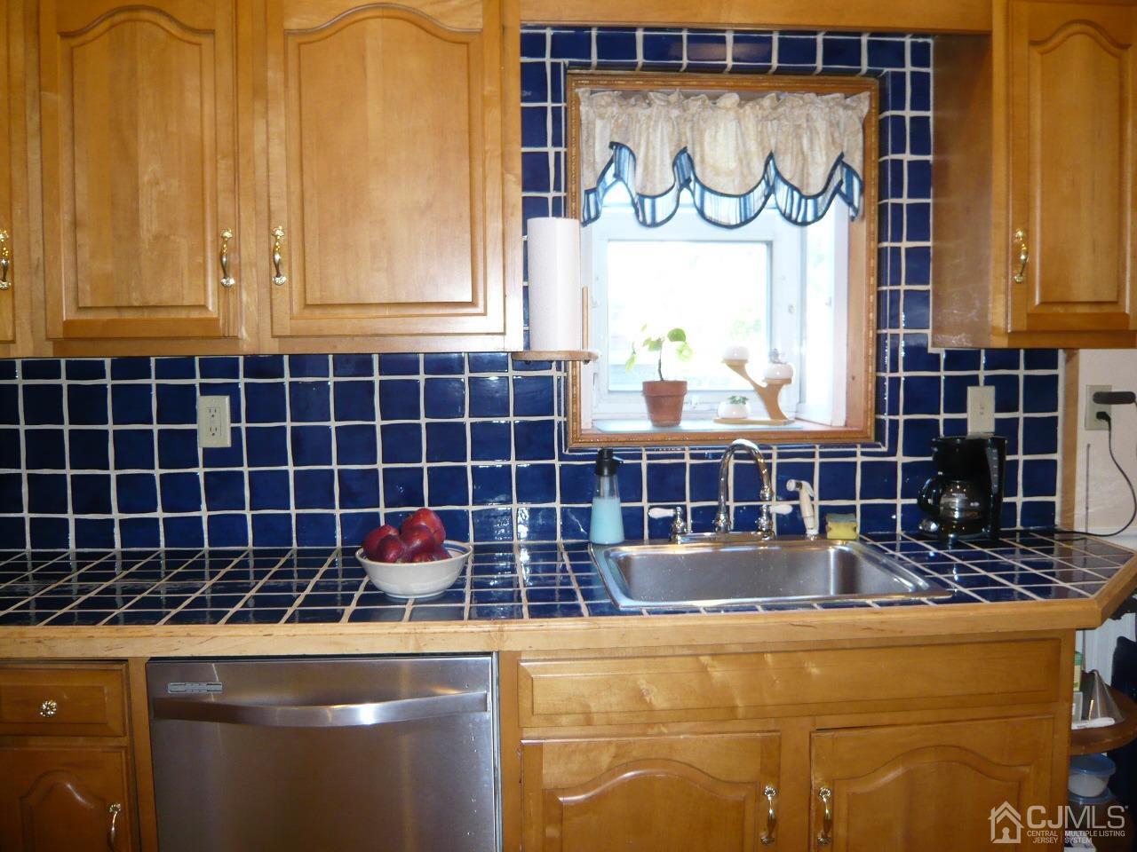 232 Rector Street Perth Amboy, NJ 08861 - Photo 15 of 31 a room with blue cabinets and a wooden floor