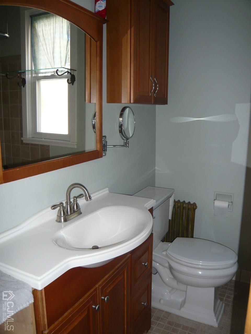 232 Rector Street Perth Amboy, NJ 08861 - Photo 18 of 31 a bathroom with a sink a toilet and window