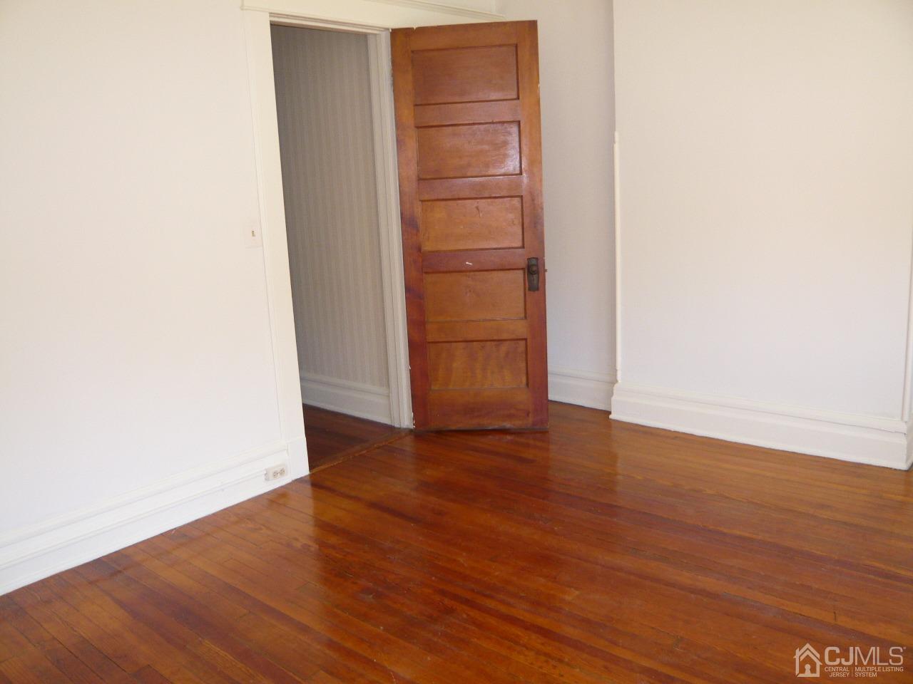 232 Rector Street Perth Amboy, NJ 08861 - Photo 26 of 31 a view of an empty room with wooden floor