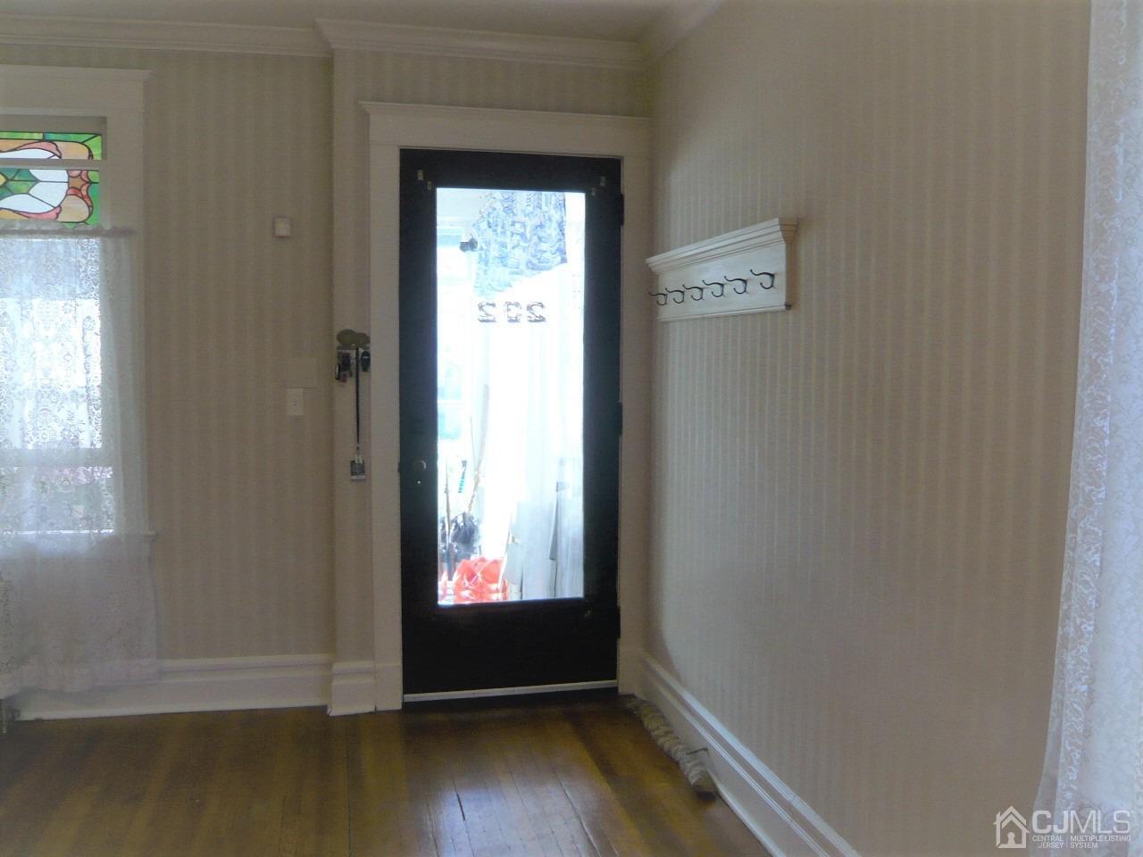 232 Rector Street Perth Amboy, NJ 08861 - Photo 31 of 31 an empty room with wooden floor and windows