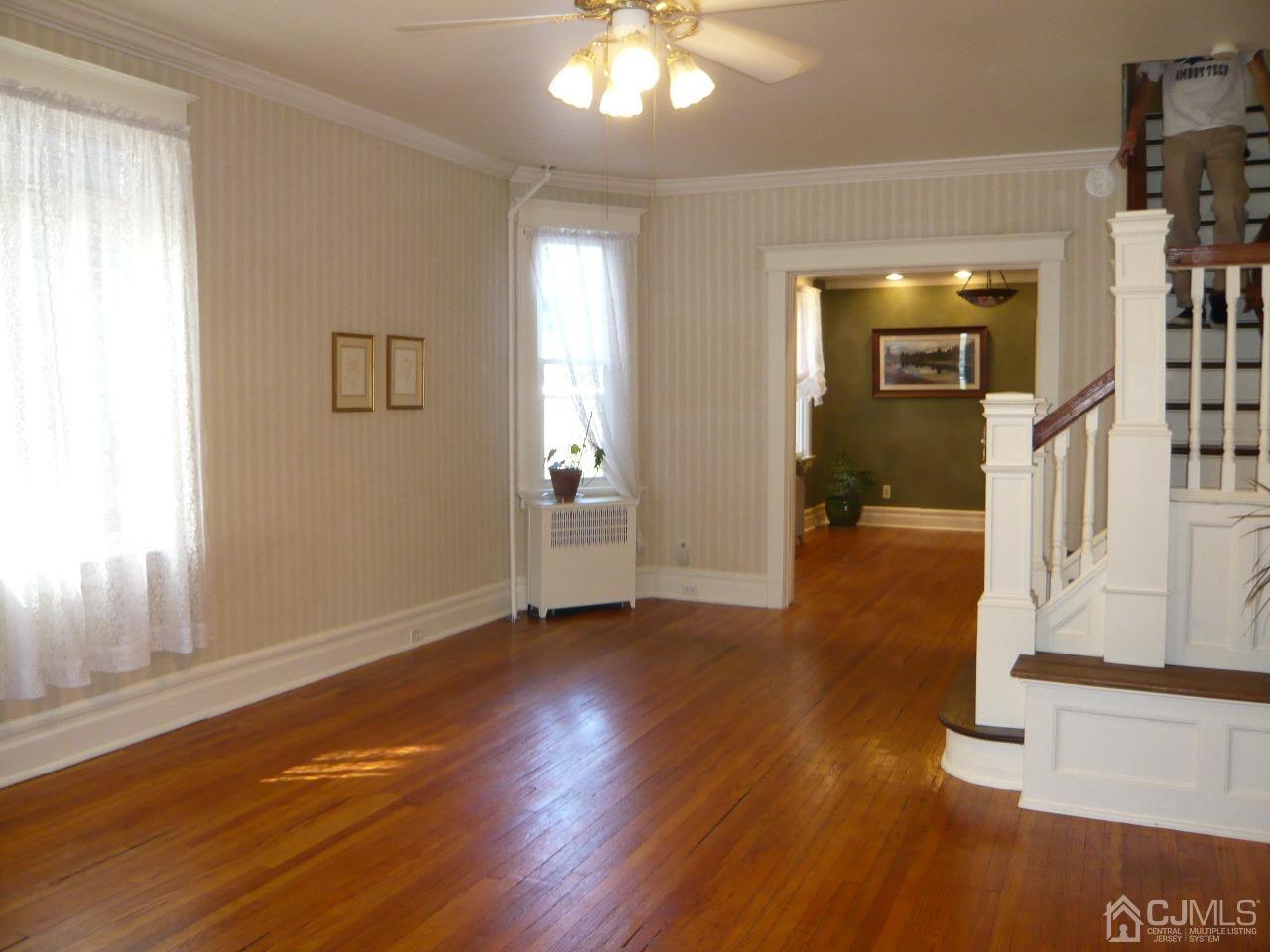 232 Rector Street Perth Amboy, NJ 08861 - Photo 8 of 31 wooden floor in an empty room with a window