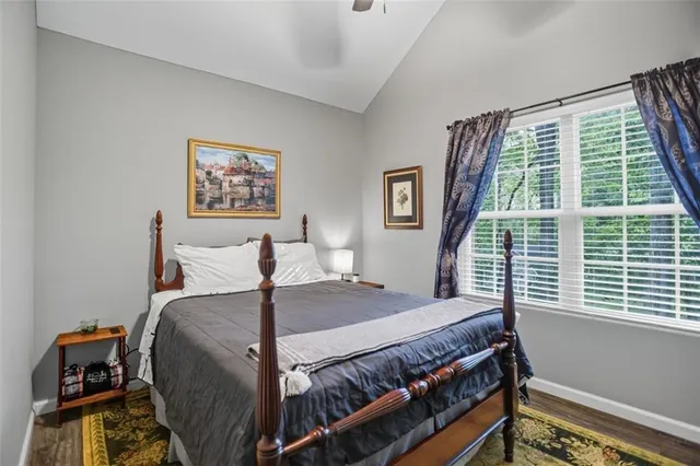 a bed sitting in a bedroom next to a window
