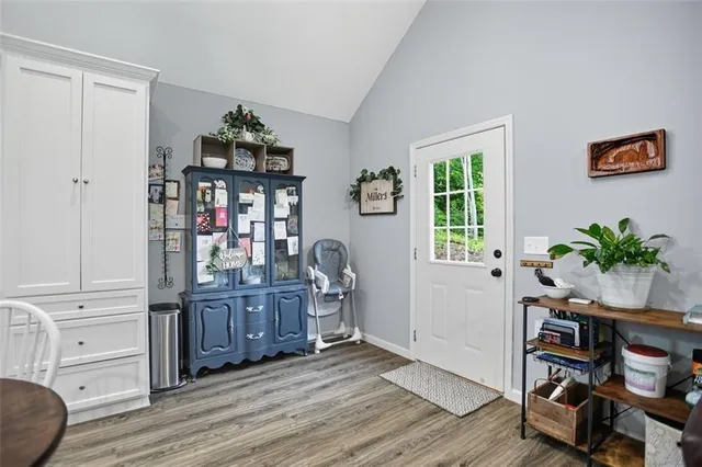 a view of a workspace with furniture and a window