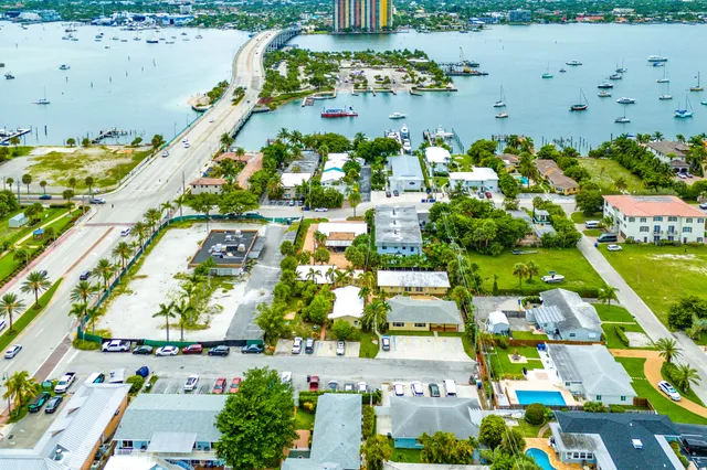 an aerial view of a house with a garden and lake view
