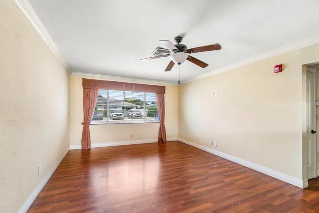 a kitchen with granite countertop a refrigerator stove and cabinets
