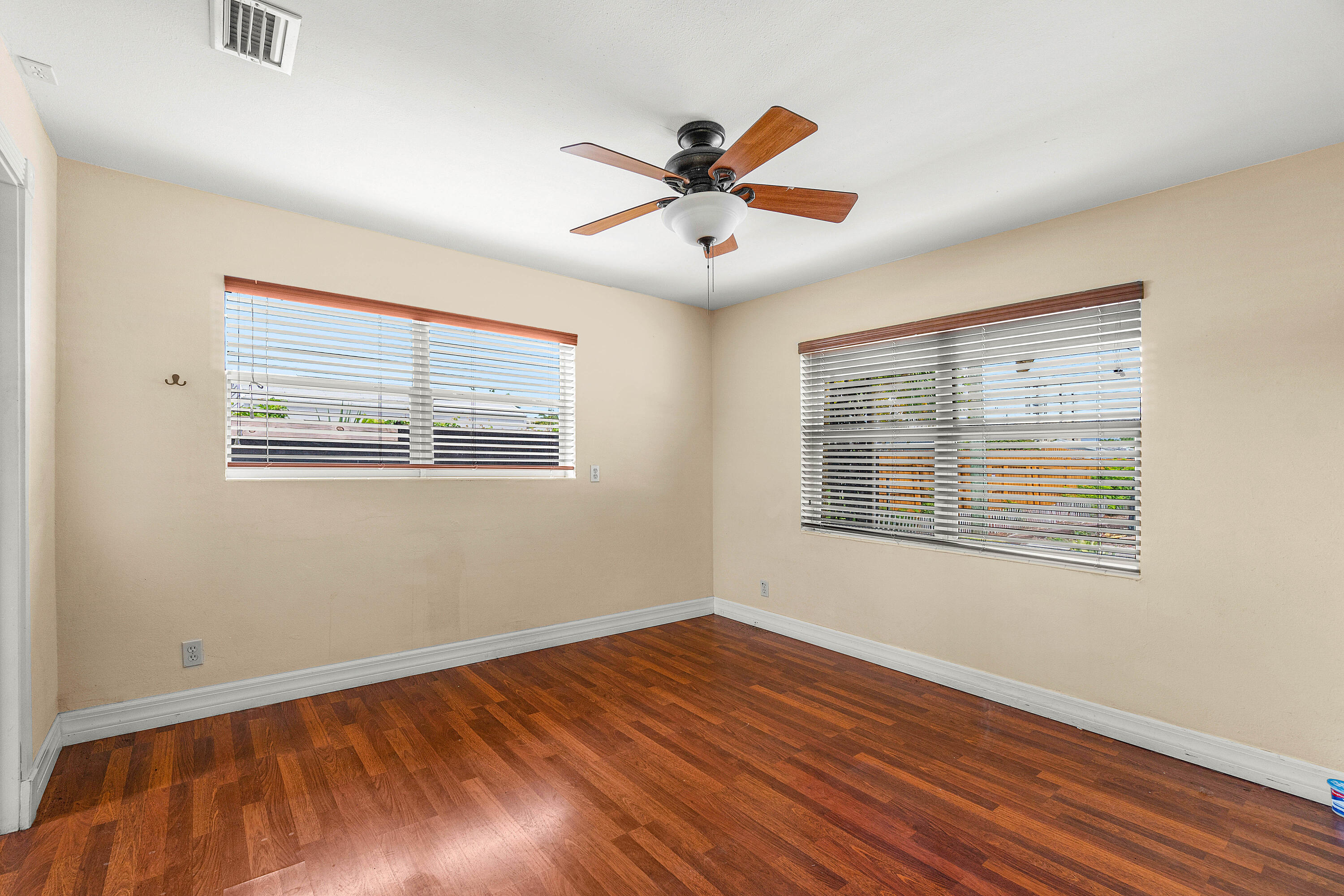2637 West West Way, Unit A Riviera Beach, FL 33404 - Photo 39 of 42 a view of an empty room with wooden floor and a window