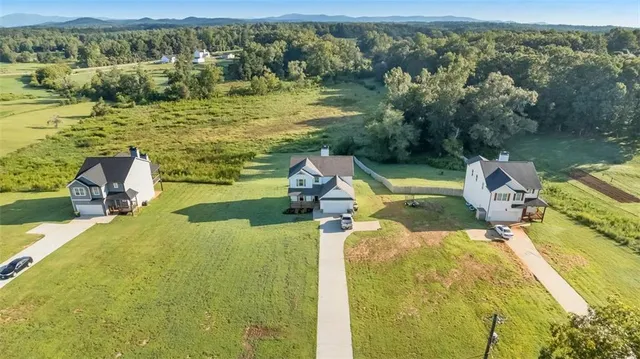 a view of a backyard with table and chairs