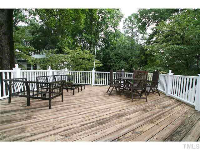 2112 Fairview Road Raleigh, NC 27608 - Photo 16 of 25 a view of a deck with table and chairs and wooden floor