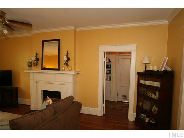 2112 Fairview Road Raleigh, NC 27608 - Photo 5 of 25 a view of living room with a fireplace and wooden floor