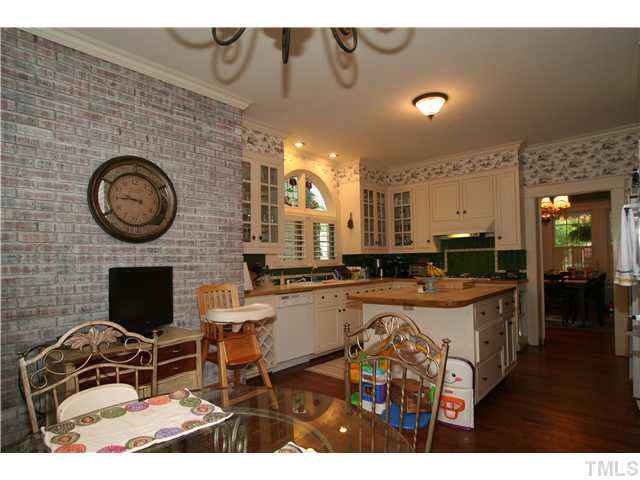 2112 Fairview Road Raleigh, NC 27608 - Photo 10 of 25 a living room with stainless steel appliances furniture a rug and a fireplace