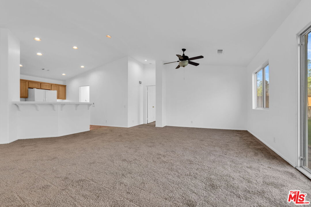 30940 Robert Road Thousand Palms, CA 92276 - Photo 15 of 48 an empty room with a ceiling fan and a window