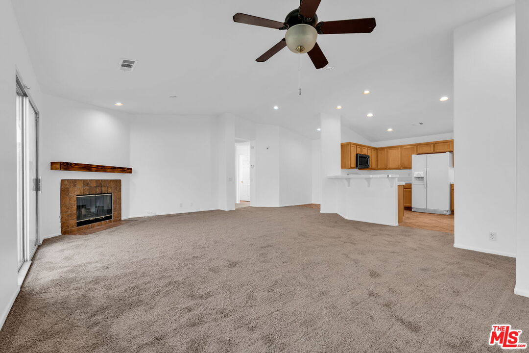 30940 Robert Road Thousand Palms, CA 92276 - Photo 16 of 48 a view of empty room with a fireplace and window