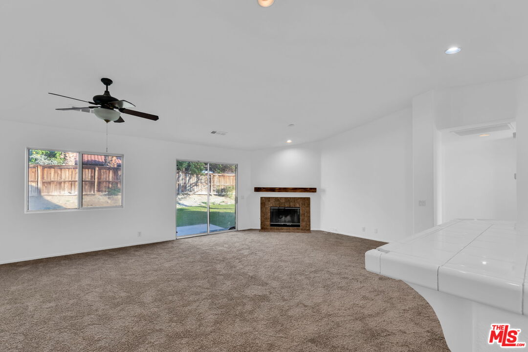 30940 Robert Road Thousand Palms, CA 92276 - Photo 18 of 48 a view of a livingroom with a fireplace and window