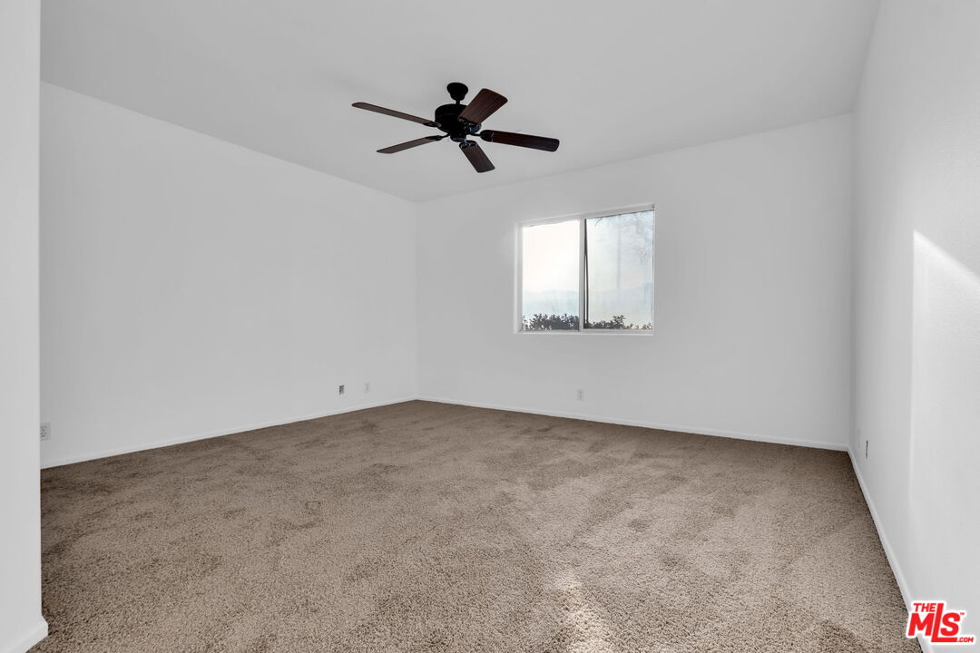30940 Robert Road Thousand Palms, CA 92276 - Photo 26 of 48 an empty room with windows and fan view
