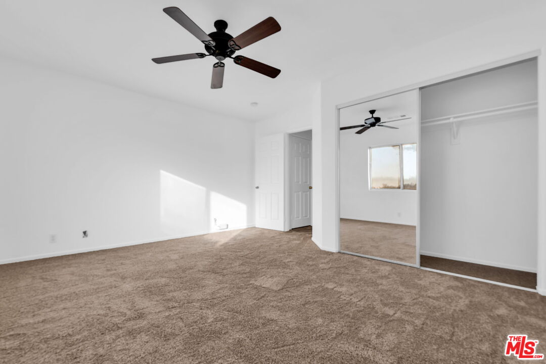 30940 Robert Road Thousand Palms, CA 92276 - Photo 27 of 48 an empty room with a ceiling fan and a window