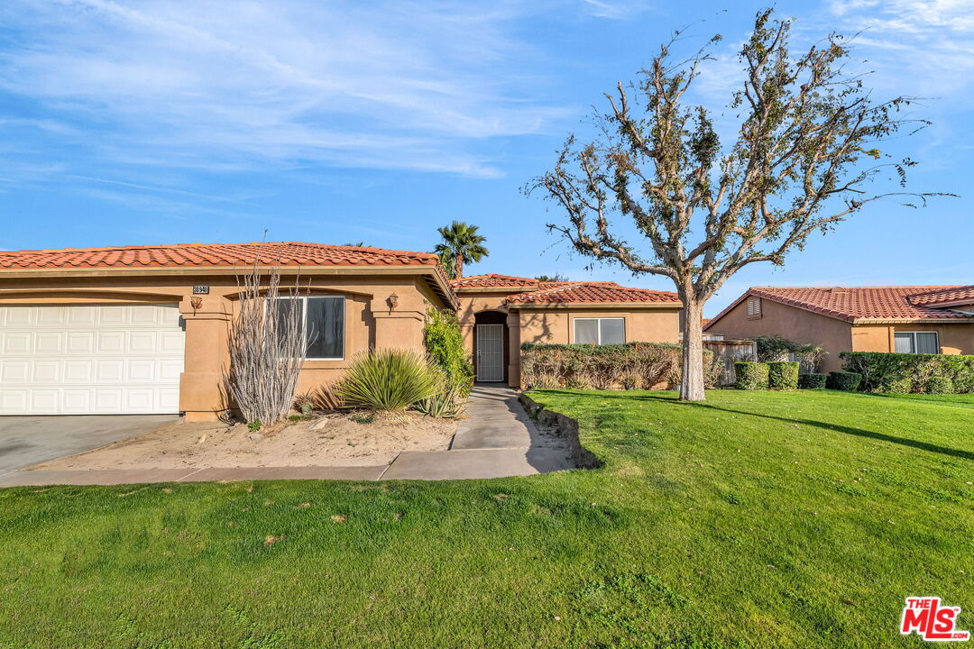 30940 Robert Road Thousand Palms, CA 92276 - Photo 3 of 48 a front view of a house with a garden