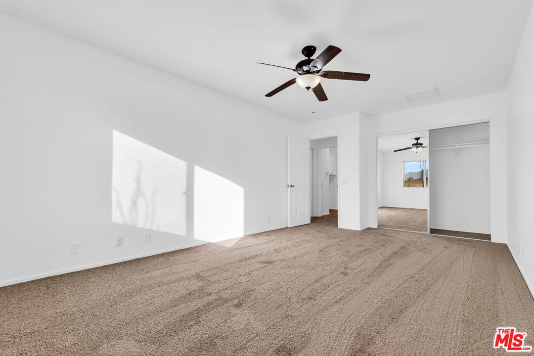 30940 Robert Road Thousand Palms, CA 92276 - Photo 31 of 48 a view of empty room with windows and ceiling fan view