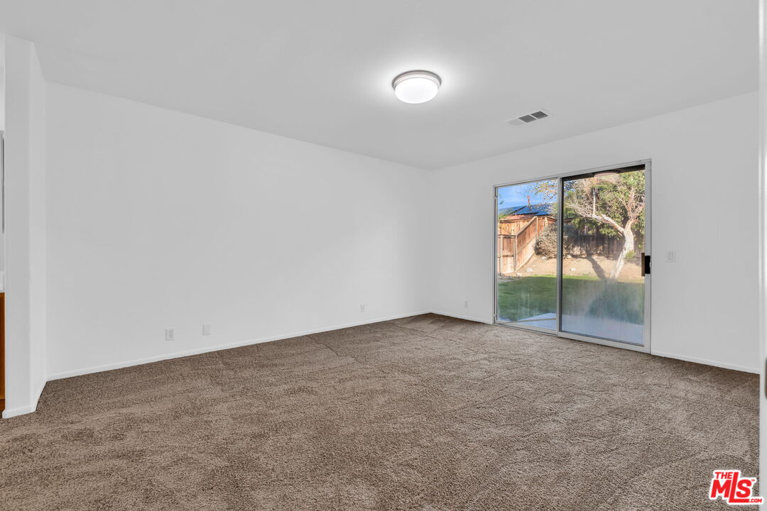 30940 Robert Road Thousand Palms, CA 92276 - Photo 32 of 48 an empty room with sliding door