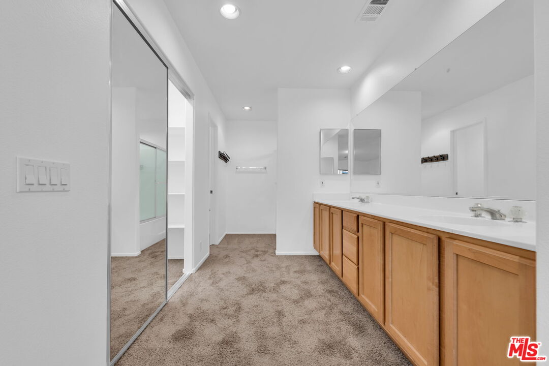 30940 Robert Road Thousand Palms, CA 92276 - Photo 35 of 48 a view of a hallway with wooden cabinets