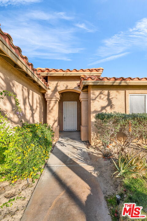 30940 Robert Road Thousand Palms, CA 92276 - Photo 6 of 48 a view of a brick house with a large windows