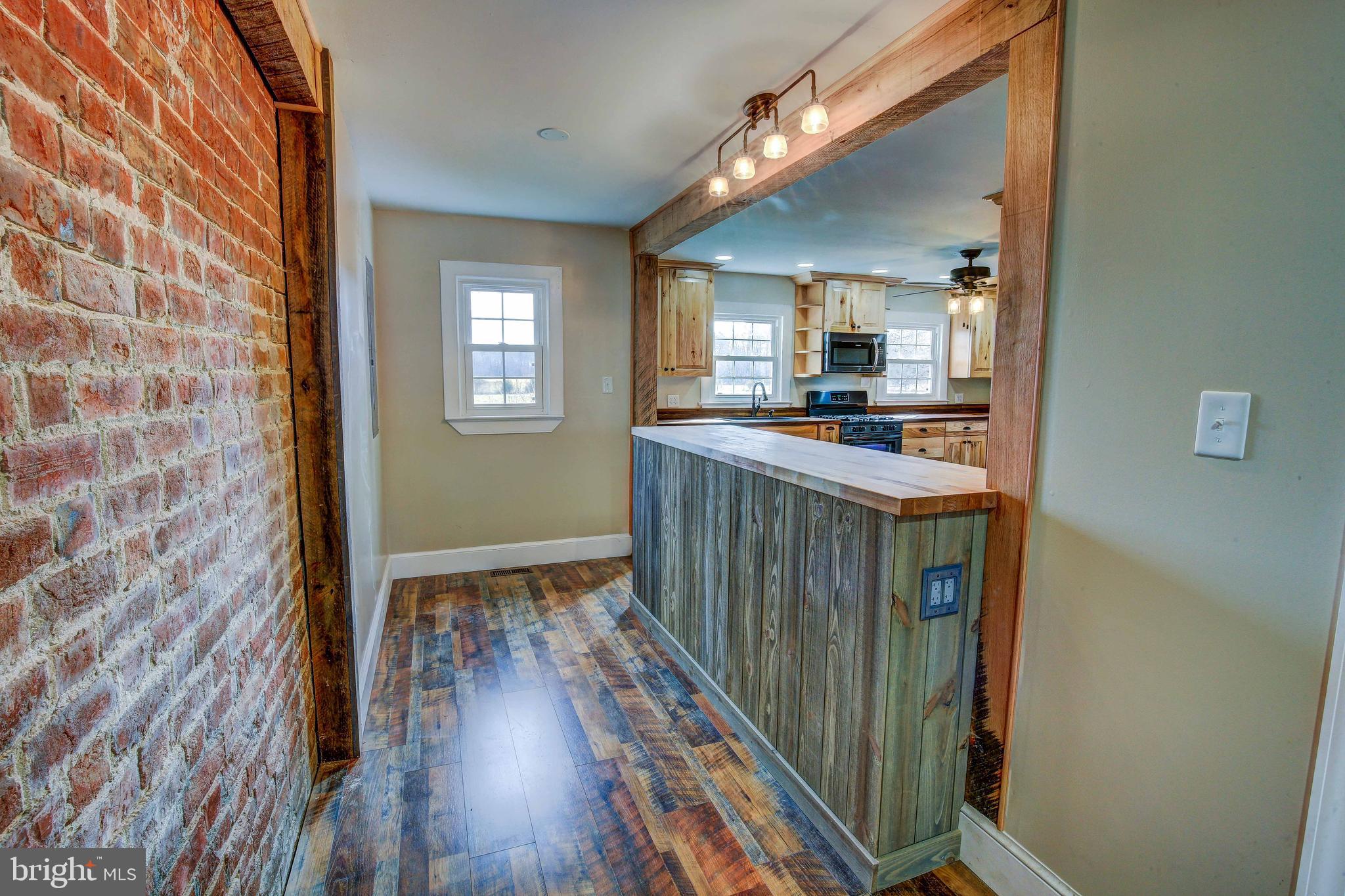 25208 Jerusalem Road Milford, VA 22514 - Photo 7 of 58 Kitchen with Exposed Brick and Beams