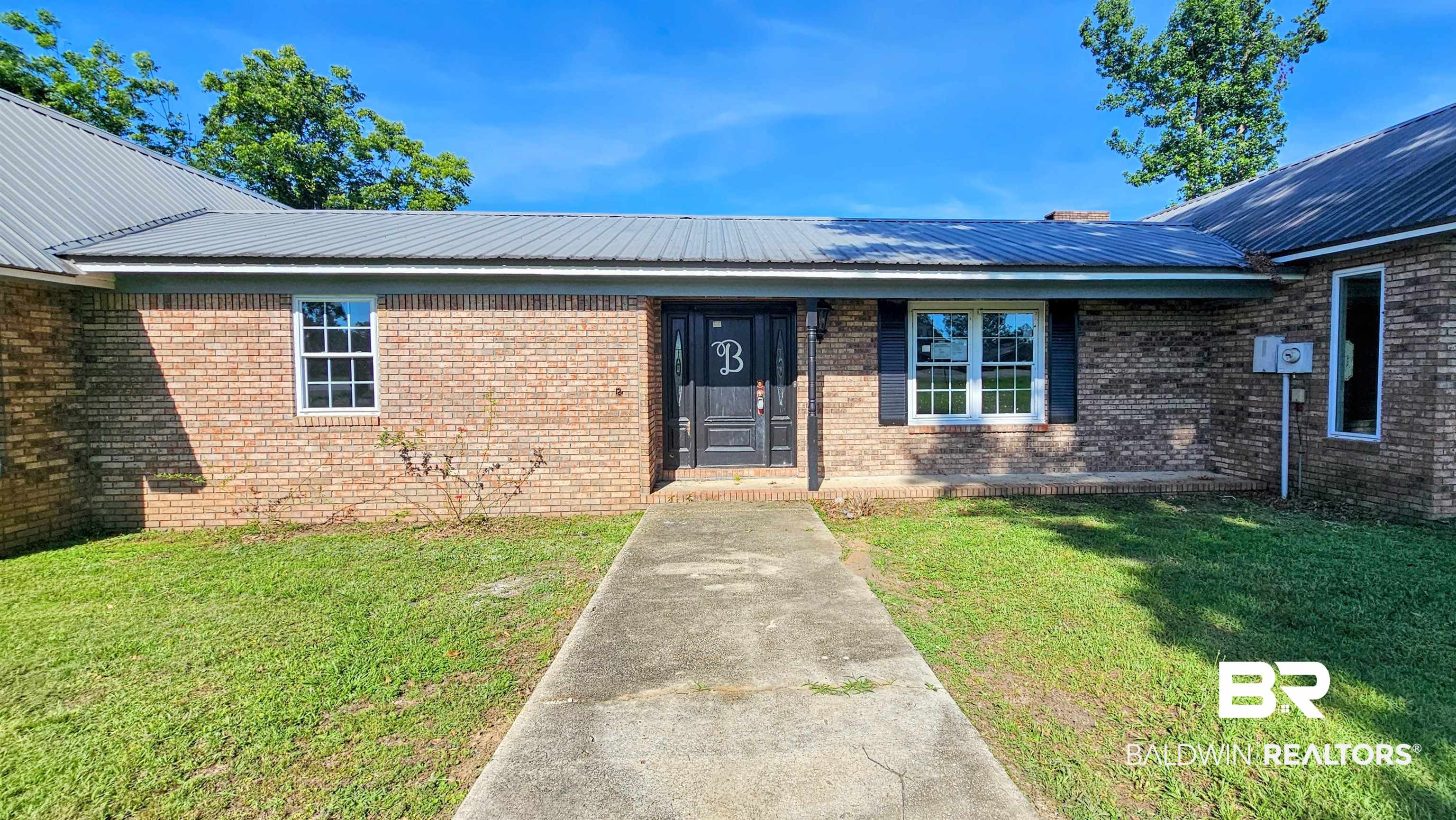 18824 Highway 41 Brewton, AL 36426 - Photo 3 of 40 Brick exterior with a gray metal roof