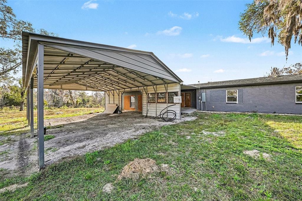 27178 Hickory Hill Road Brooksville, FL 34602 - Photo 6 of 18 a view of a house with a backyard