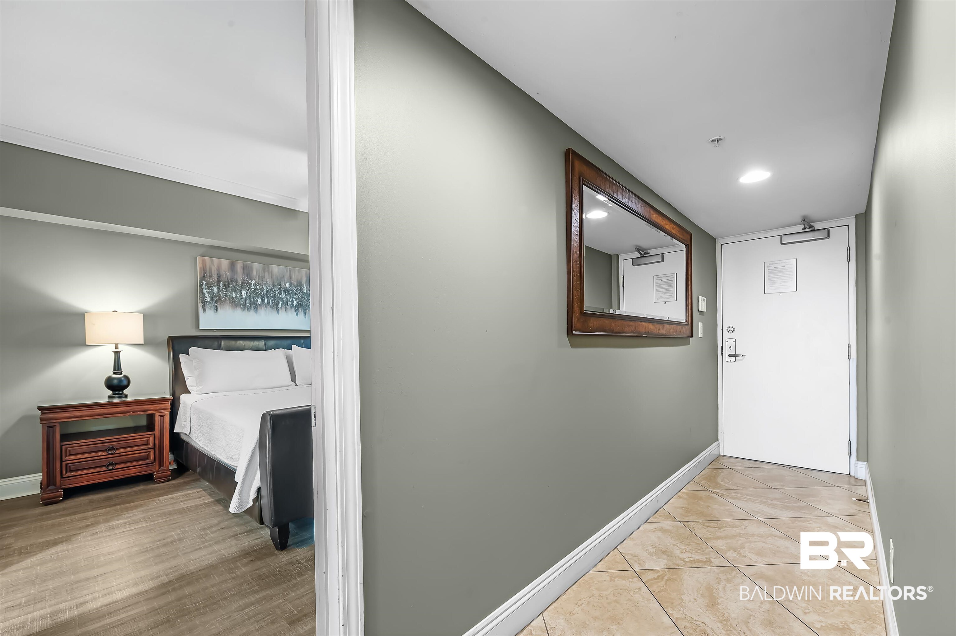 16287 Perdido Key Drive, Unit 105 Pensacola, FL 32507 - Photo 7 of 66 Entryway featuring tile flooring, a white door, and a decorative mirror
