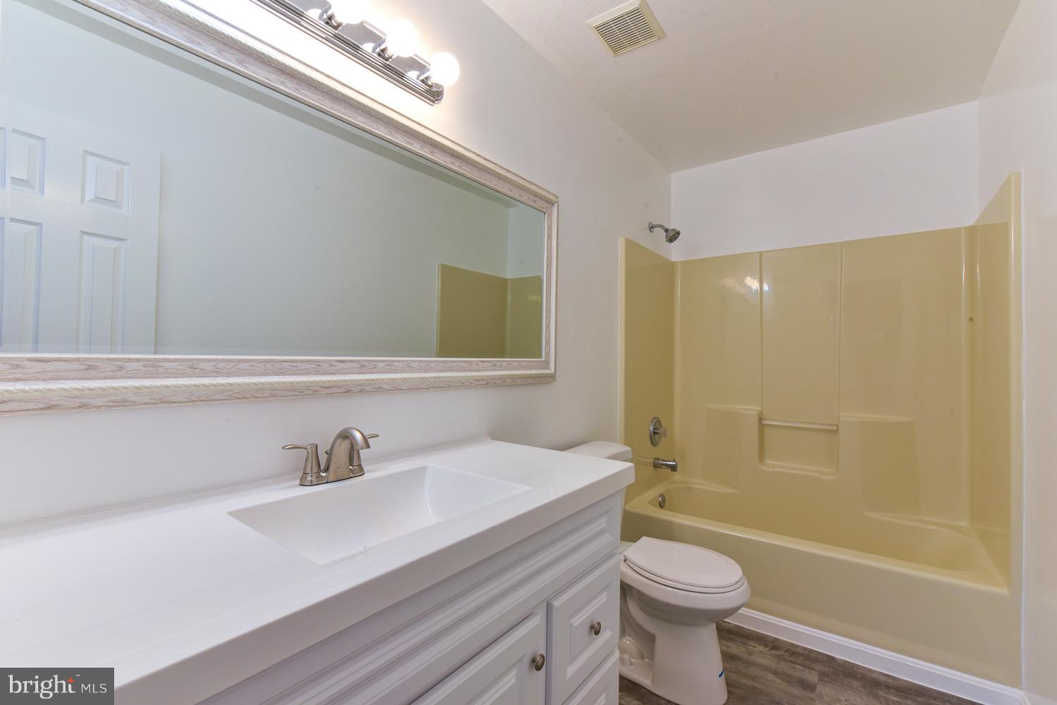 6507 Ronald Road Capitol Heights, MD 20743 - Photo 13 of 30 a bathroom with a sink a toilet and shower