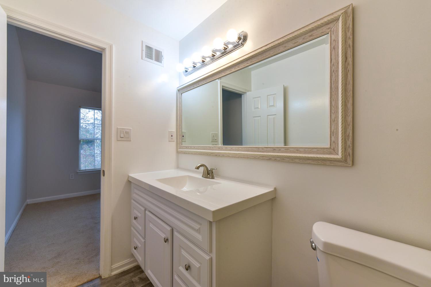 6507 Ronald Road Capitol Heights, MD 20743 - Photo 14 of 30 a bathroom with a toilet sink and mirror