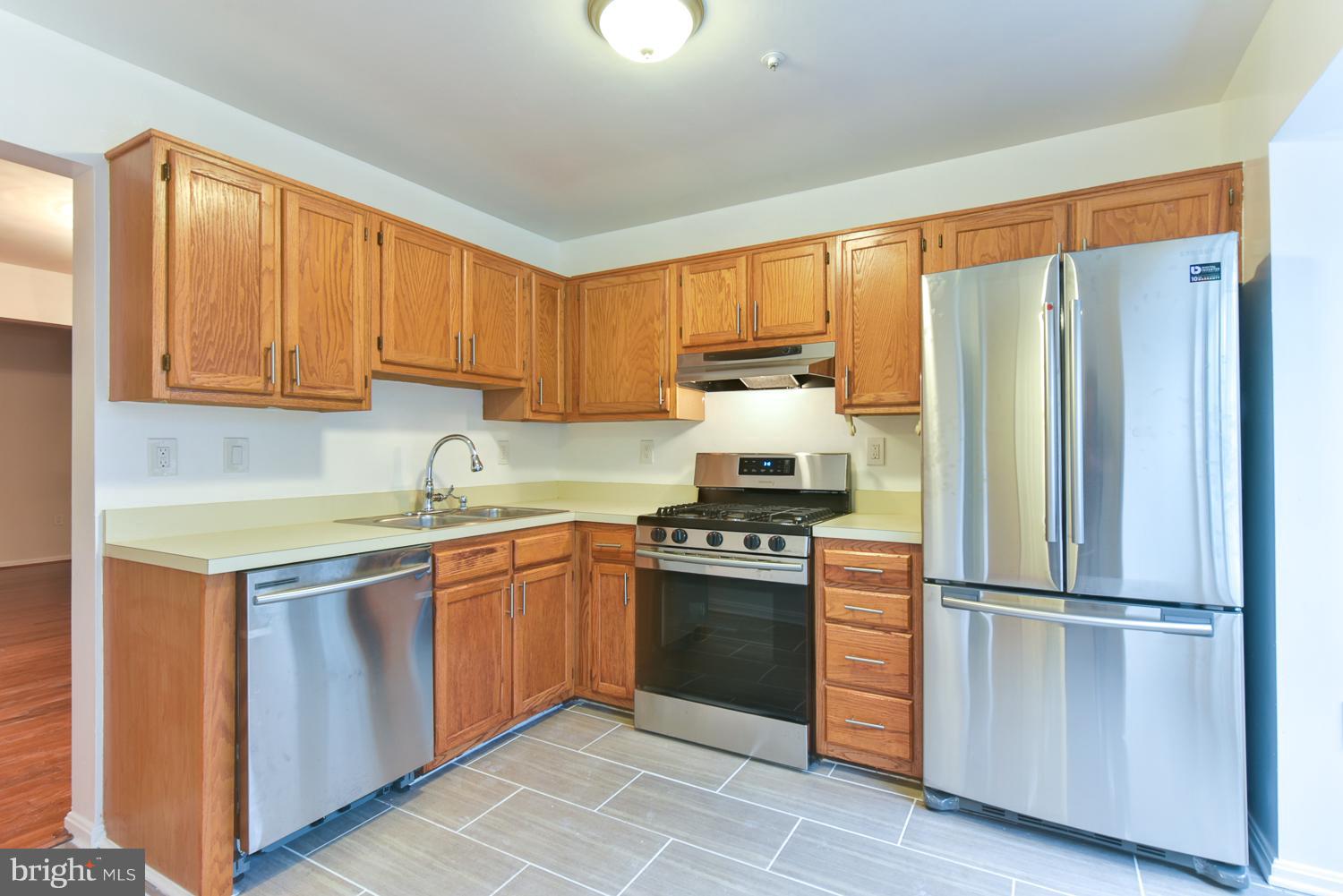 6507 Ronald Road Capitol Heights, MD 20743 - Photo 3 of 30 a kitchen with stainless steel appliances granite countertop a refrigerator sink and stove