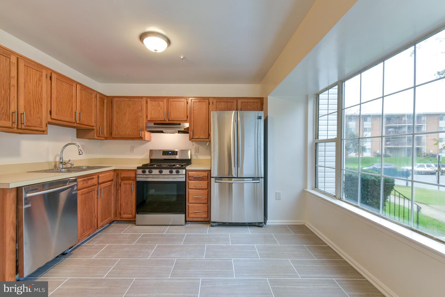 6507 Ronald Road Capitol Heights, MD 20743 - Photo 4 of 30 a kitchen with stainless steel appliances granite countertop a stove a sink and a refrigerator