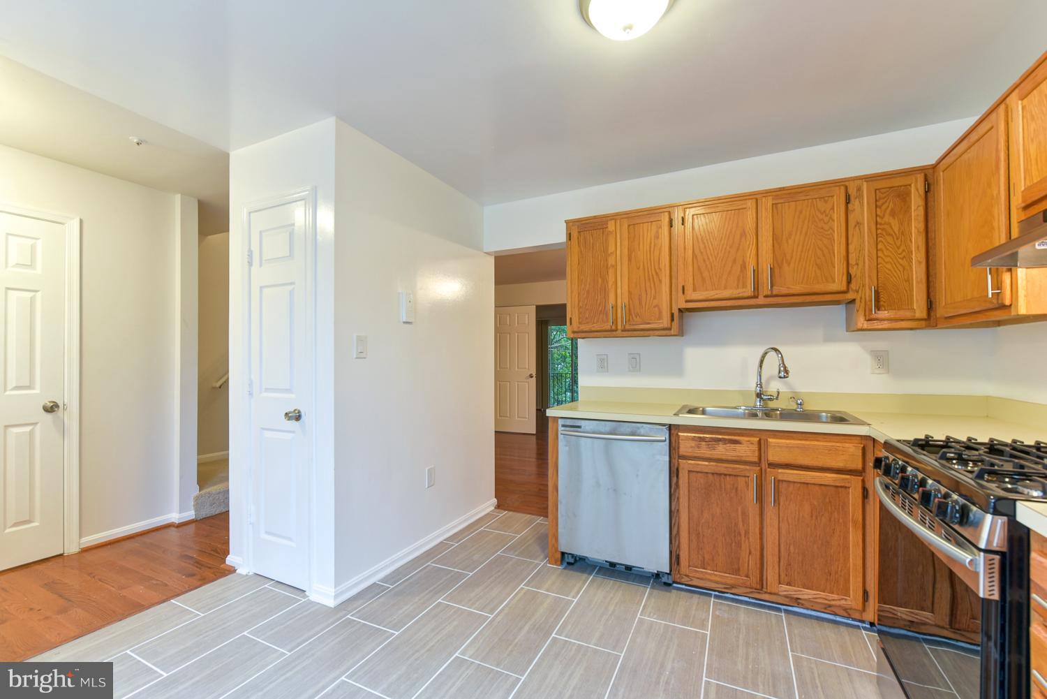 6507 Ronald Road Capitol Heights, MD 20743 - Photo 6 of 30 a kitchen with stainless steel appliances granite countertop a sink stove and refrigerator