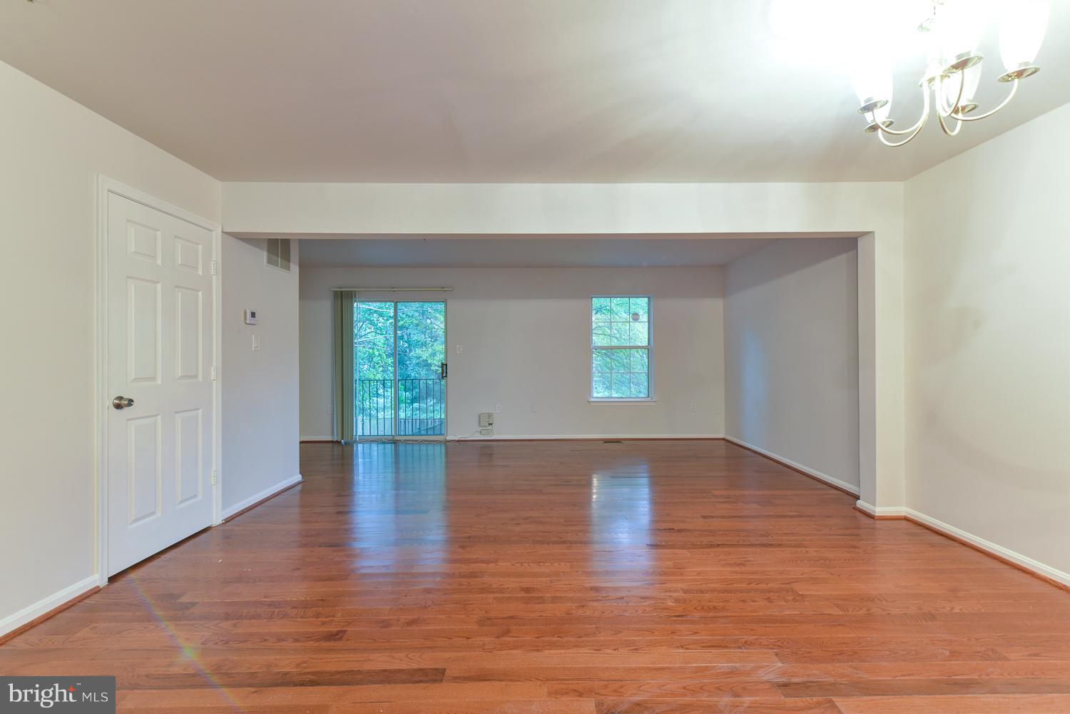 6507 Ronald Road Capitol Heights, MD 20743 - Photo 7 of 30 a view of an empty room with wooden floor and a window