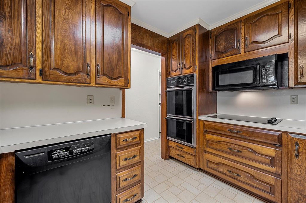 219 Opal Street Hewitt, TX 76643 - Photo 8 of 28 a kitchen with stainless steel appliances granite countertop a stove microwave and refrigerator