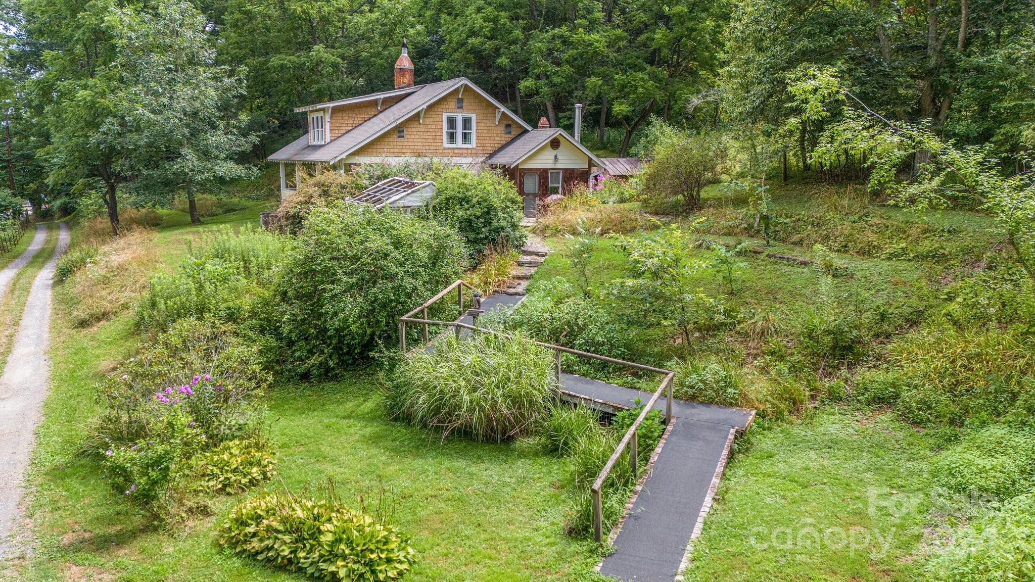 71 Persimmon Lane Canton, NC 28716 - Photo 1 of 41 a view of a house with a yard and plants