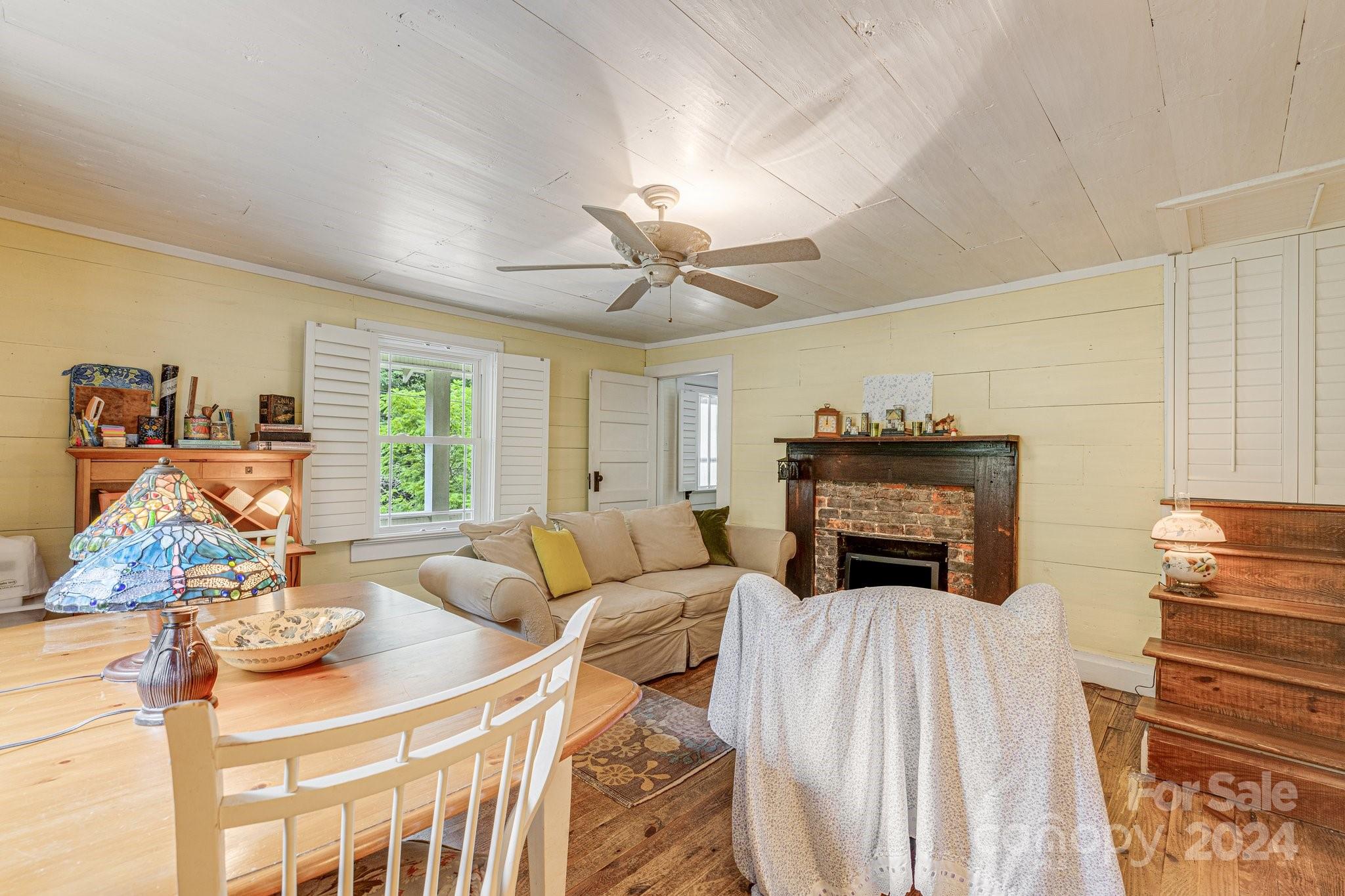 71 Persimmon Lane Canton, NC 28716 - Photo 14 of 41 a living room with furniture a fireplace and a flat screen tv