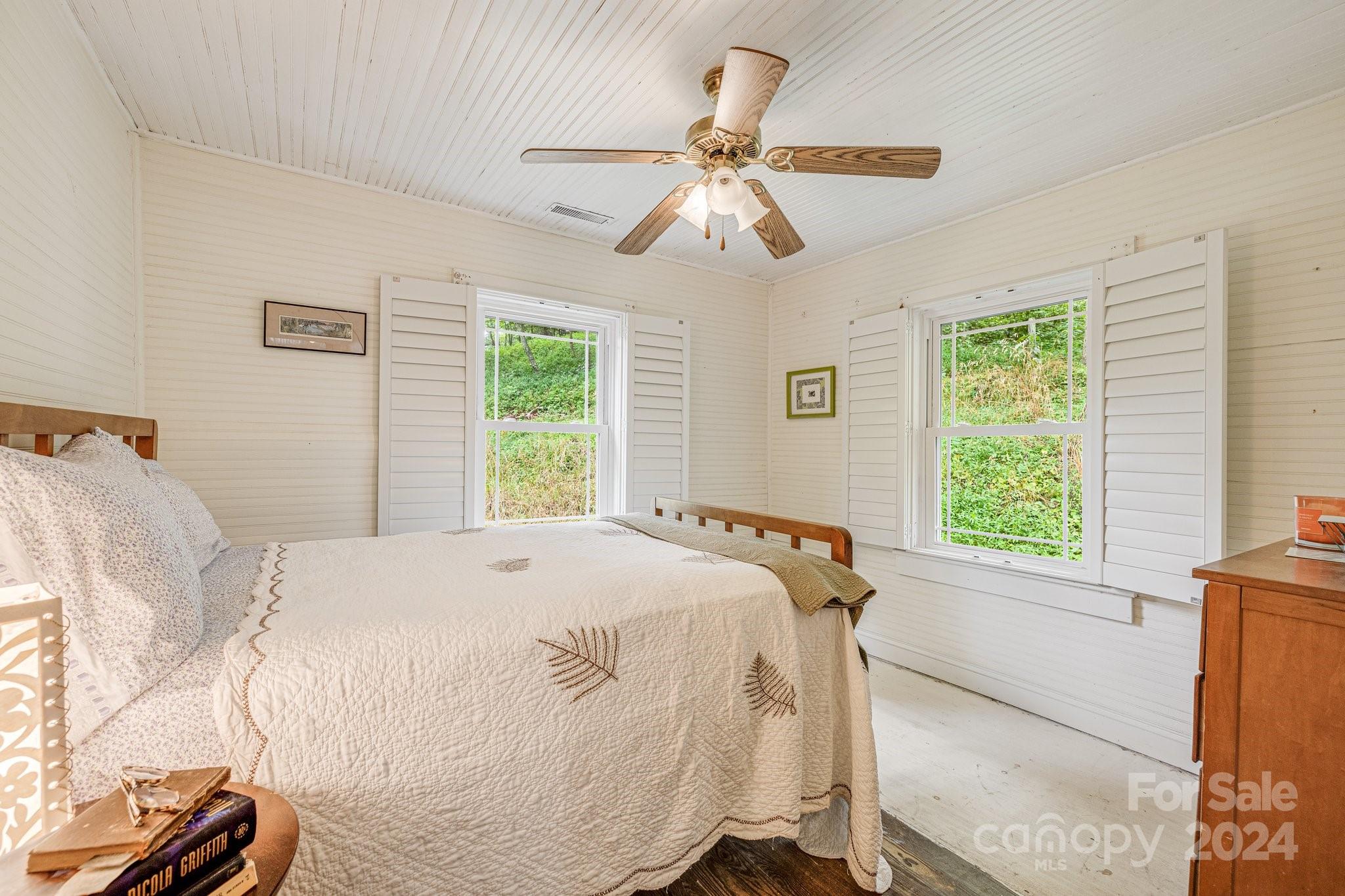 71 Persimmon Lane Canton, NC 28716 - Photo 19 of 41 a bed sitting in a bedroom next to a window