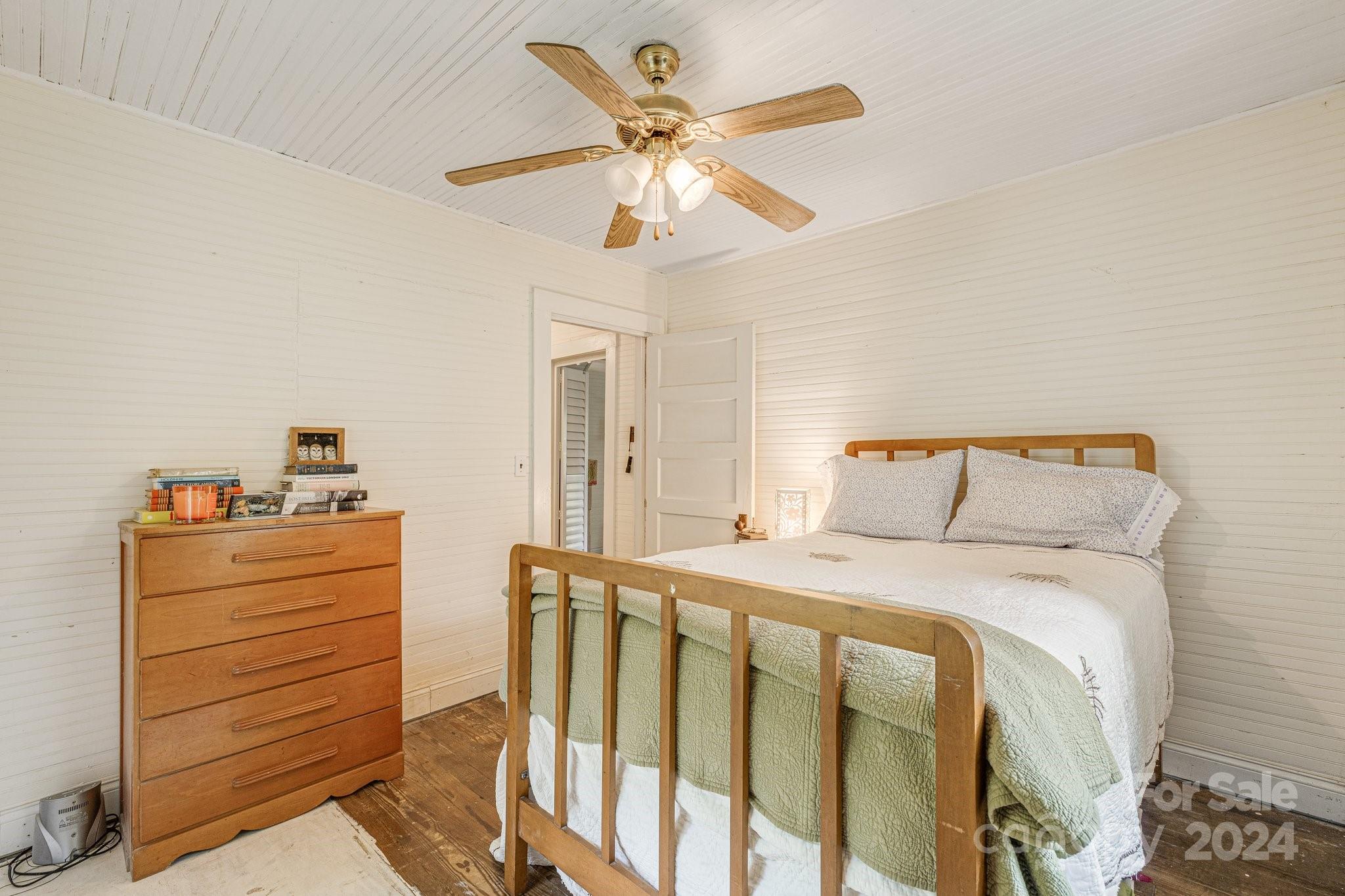 71 Persimmon Lane Canton, NC 28716 - Photo 20 of 41 a bedroom with a bed and a chandelier